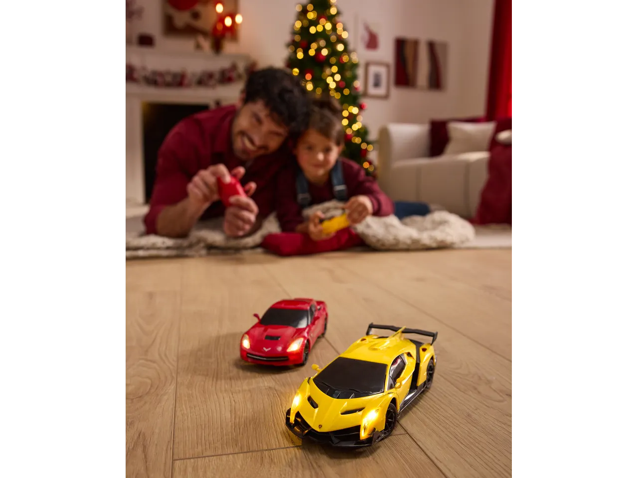 Father and child playing with Lupilu Remote Control Toy Cars on Christmas.