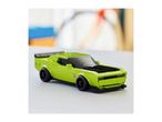 A lime green toy sports car with black accents on a light grey surface.