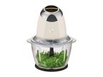 Food chopper with herbs in a glass bowl