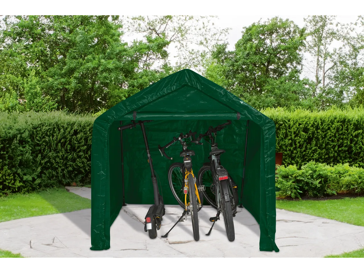 Green tent garage with bicycles and electric scooter on a concrete path.