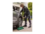 A man using a torque wrench to tighten the wheel nuts on a car.