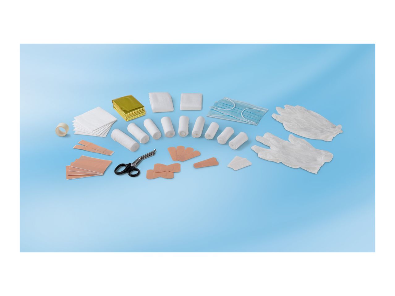 A variety of first aid supplies, including bandages, gauze, tape, masks, and gloves.