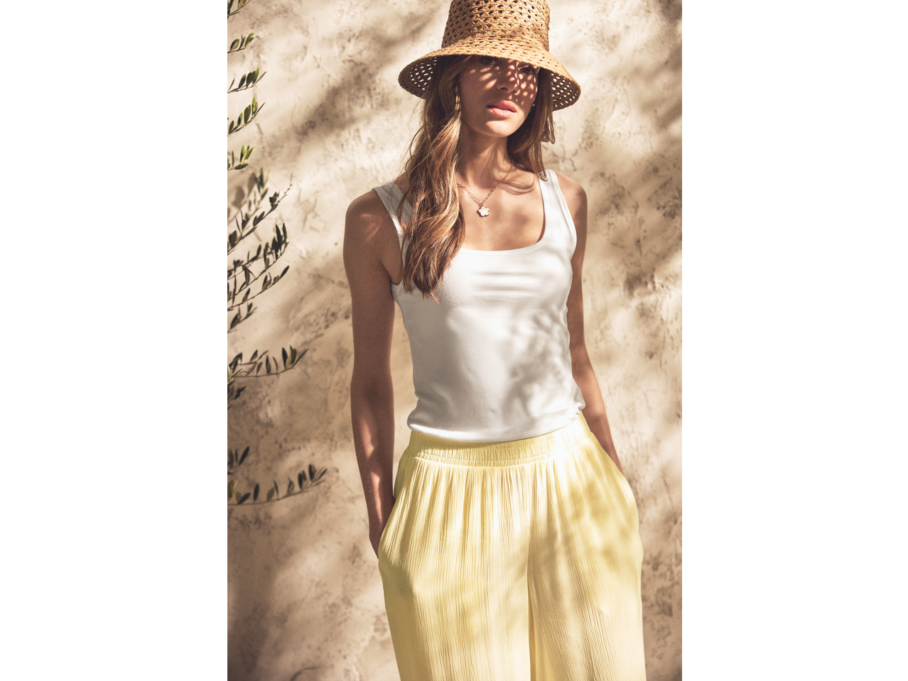 Esmara Ladies' Wide Leg Trousers in yellow, with a white tank top and straw hat.