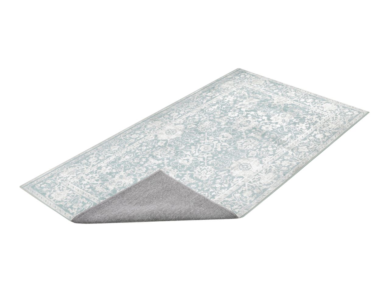 Light blue patterned rug with a non-slip backing shown folded over at one corner