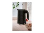 Black electric kettle with a textured honeycomb design on a wooden kitchen counter.