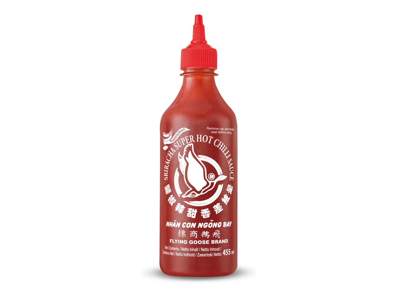 Een fles hete sriracha chilisaus met een rode dop tegen een zwarte achtergrond.