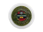 A clear plastic container of spicy Latin American style chimichurri sauce.