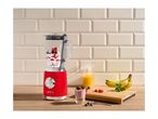 Red retro blender with ingredients, a smoothie glass, and fresh fruit on a wooden counter.