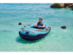 Man rowing a Crivit inflatable boat at sea.