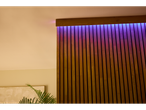 A modern wooden wall with purple LED lighting.