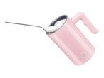 Pink milk frother with a spoon full of foam being added to it.