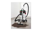 Wet and dry vacuum cleaner with a pile of dirt on a tiled floor