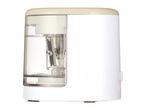 A white electric pencil sharpener with a transparent shavings container.