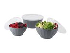 Three grey bowls with white lids, two filled with berries and salad, on a white background.