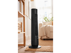 Black tower fan and heater in a living room.