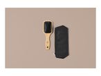 A wooden hairbrush with black bristles and a black zippered pouch on a beige background.