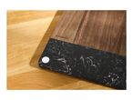 Wooden cutting board with a black marble-effect section and a white circular sticker.