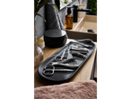 Cien BEAUTY manicure/pedicure accessories on a marble tray next to a sink.