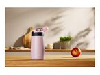 Pink water bottle with a red apple on a wooden kitchen counter
