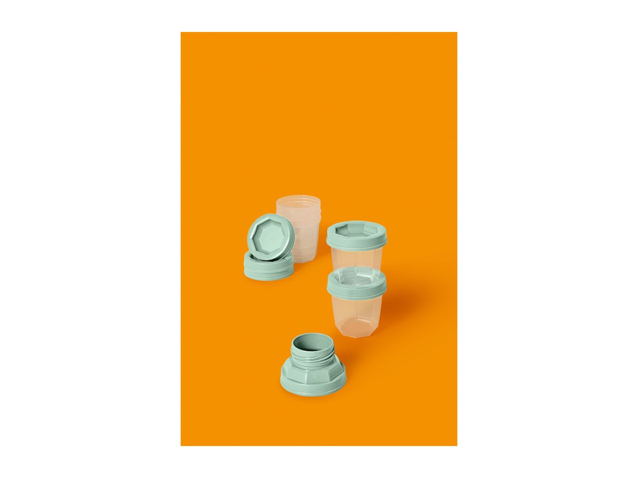 Several clear plastic food containers with light green lids on an orange background.