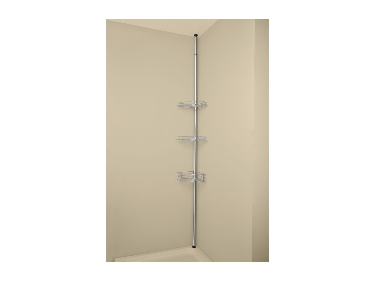 A chrome tension pole shower caddy with three corner shelves in a beige shower.
