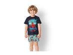 Smiling boy in a dark blue t-shirt with a superhero graphic and light blue shorts with superhero masks.
