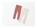 Two pairs of baby leggings, one solid dusty rose and one cream with a floral print.