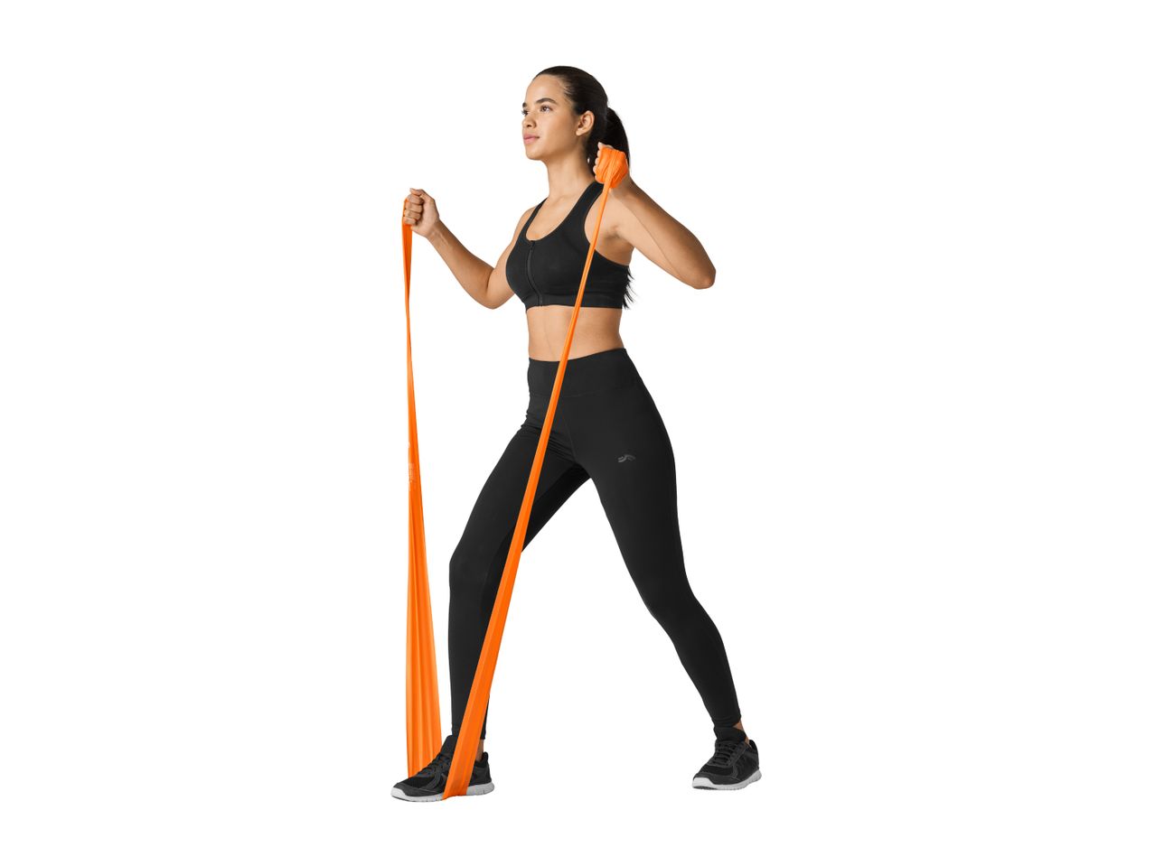 Woman in black sportswear exercising with an orange resistance band.