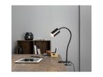 Black clip-on desk lamp illuminating a wooden desk with a tablet and office supplies.