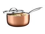 Copper-colored saucepan with a lid, filled with soup