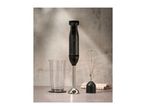 SilverCrest hand blender with whisk attachment and measuring cup on a counter.