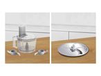 Food processor with two blades and a shredding disc on a wooden surface.