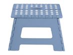 A blue plastic folding stool with white polka dots on the seat.