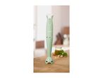 A light green SilverCrest hand blender on a wooden surface with pesto ingredients.
