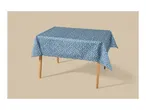 Blue tablecloth with white polka dots on a wooden table.