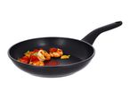 Black frying pan with cooked shrimp, cherry tomatoes, and herbs.