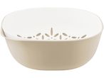 A beige plastic colander with a white inner bowl sits on a white background.