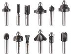 A collection of various router bits, including straight, roundover, chamfer, and cove bits.