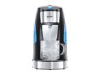 Black and silver hot water dispenser filling a glass mug with steaming water.