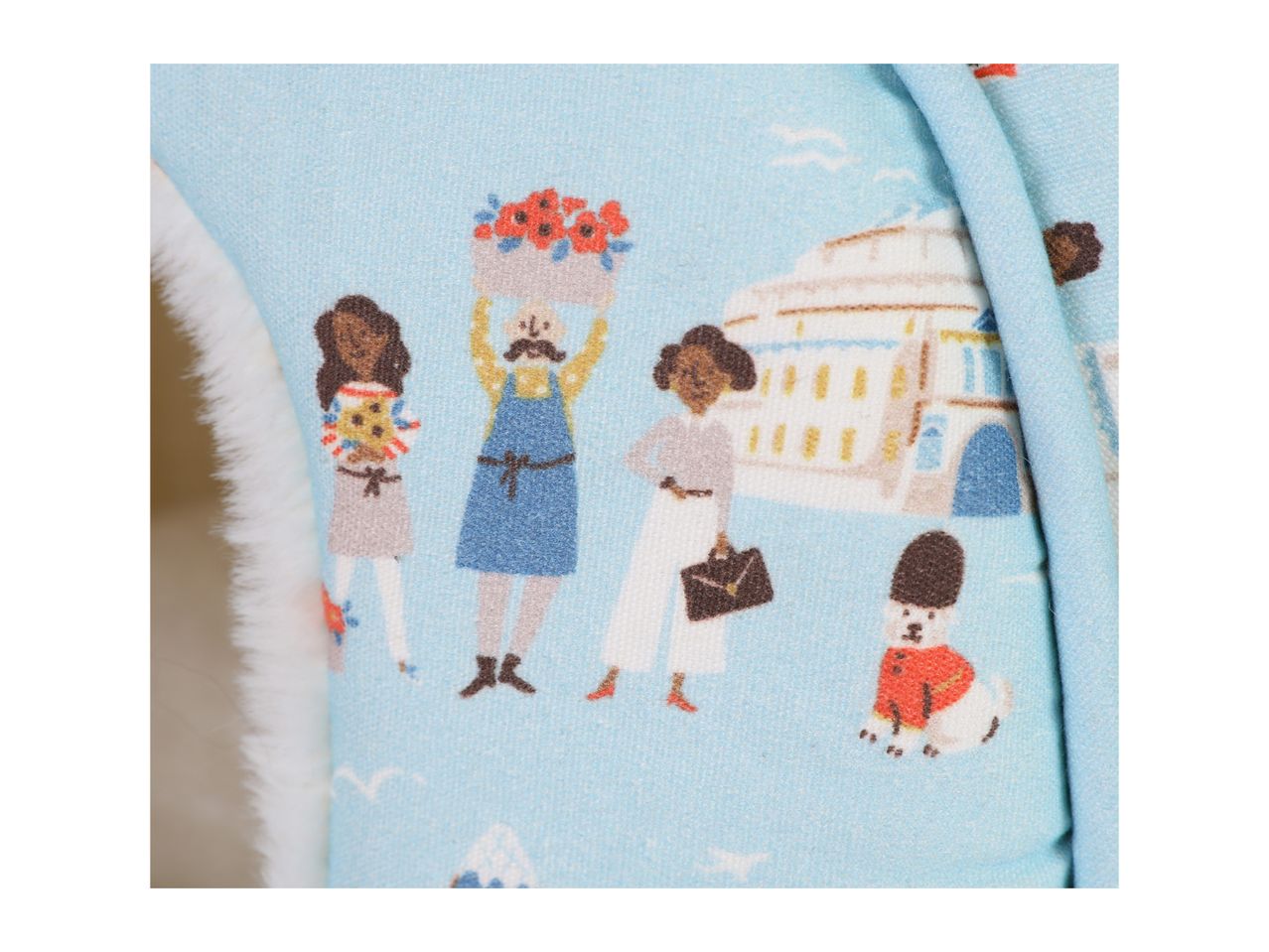 Light blue fabric with cartoon people and a dog in a guard's uniform.