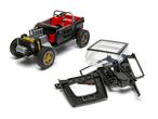 A black toy jeep with red seats and gold wheels, next to disassembled black and clear plastic parts.