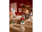 A child plays with a Lupilu remote control train on a wooden track.