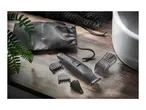 Remington G2 grooming kit with accessories on a wooden surface next to a sink.