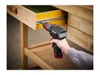 A person using a cordless drill to install a drawer slide on a wooden workbench.