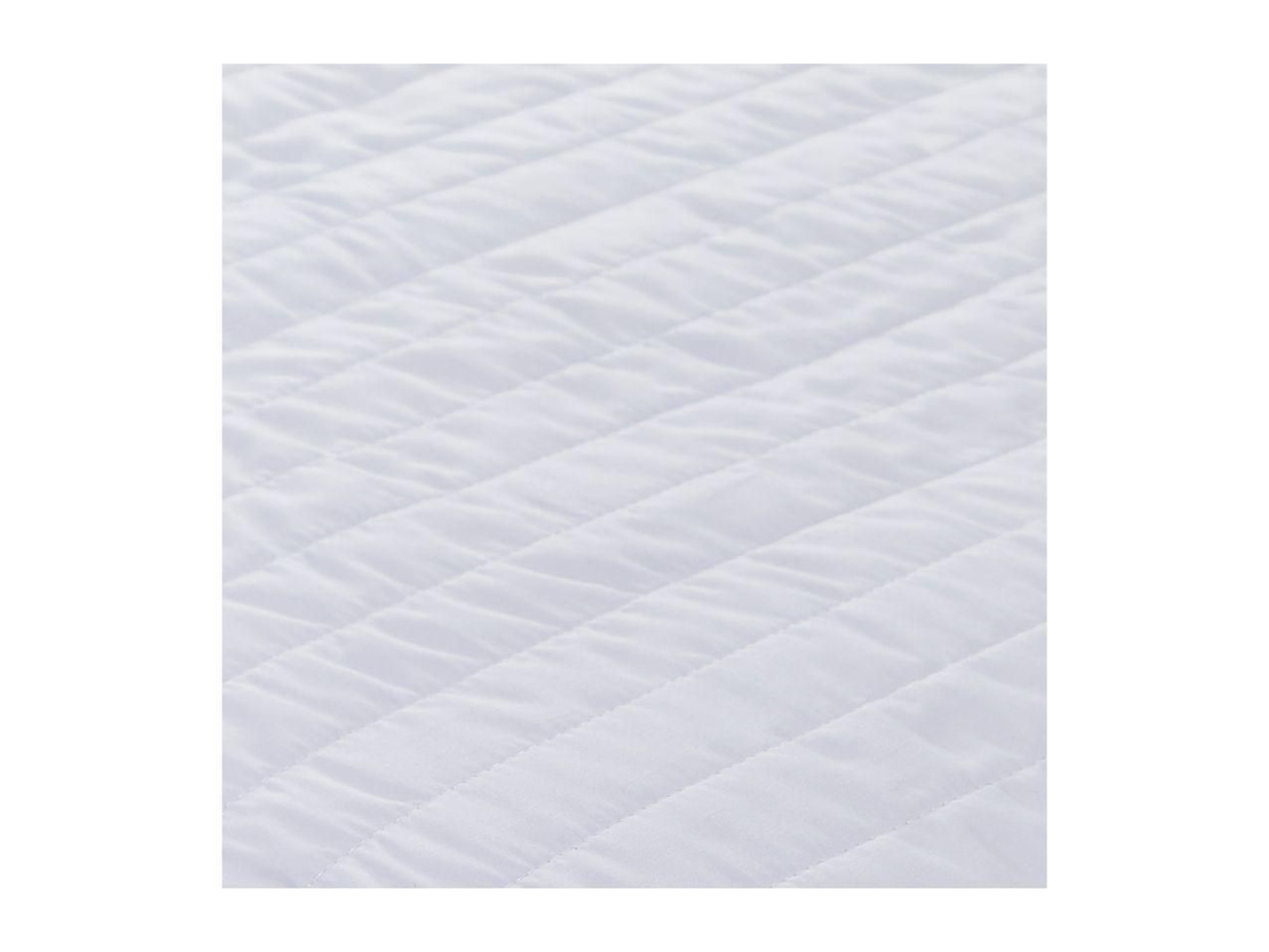 Close-up of a white quilted mattress protector or blanket, showing diagonal stitching.
