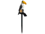 Toucan solar garden light with a black and white body, yellow beak, perched on a log.