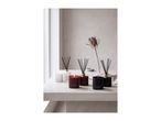 Scented candles and reed diffusers in White Musk, Wild Rose, and Sandalwood & Oud on a table.
