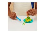 Child playing with colorful playdough spaghetti on a blue plate with a fork.