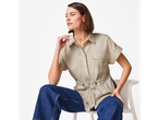 Modelo vestindo camisa bege de linho com jeans.