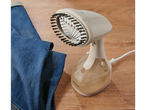 Vaporizador de roupa portátil Silvercrest com escova, ao lado de umas calças de ganga.